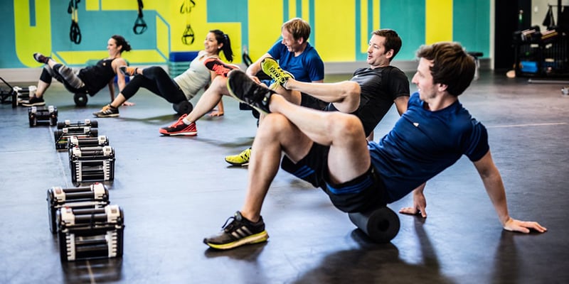 A group of Exos members stretching together, building community and caring for their well-being.