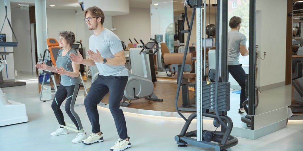A man and woman exercising in an office gym
