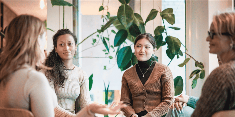 A group of women holding a meeting